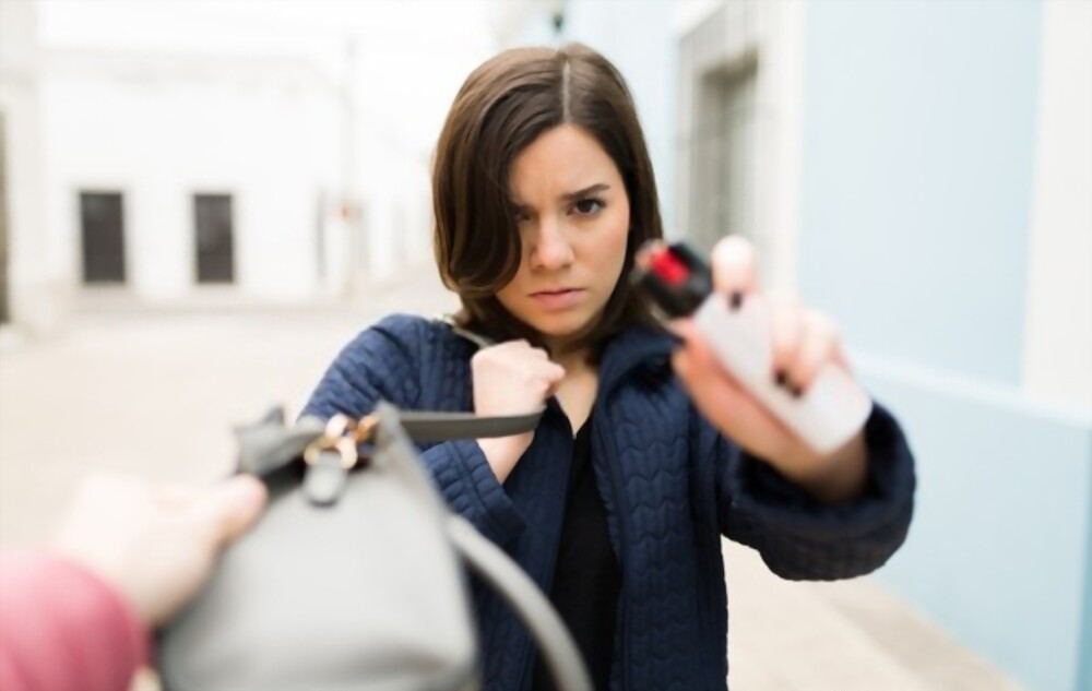 A woman using a pepper spray for protection
